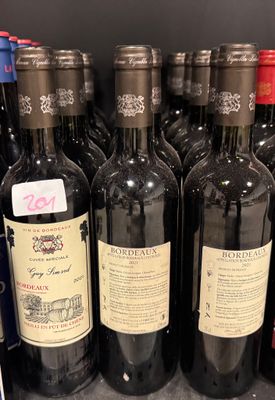 several bottles of wine are lined up on a shelf in a store