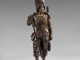 a bronze figure of a soldier with a rifle
