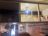 a bar with a lot of wine glasses on the shelves