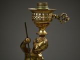 bronze figurine of a boy with a lamp on his head
