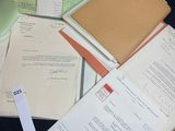 a pile of papers sitting on top of a black table