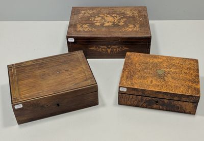 three wooden boxes sitting on top of a table next to each other