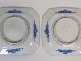pair of blue and white plates on a white surface