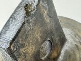 a close up of a metal object with a hole in it
