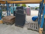 a large stack of boxes and pallets in a warehouse