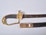 pair of antique swords with gold accents on a white surface