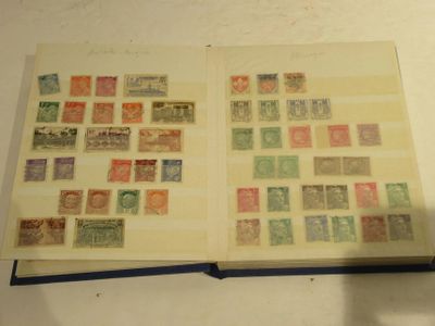 an open book with stamps on it sitting on a table