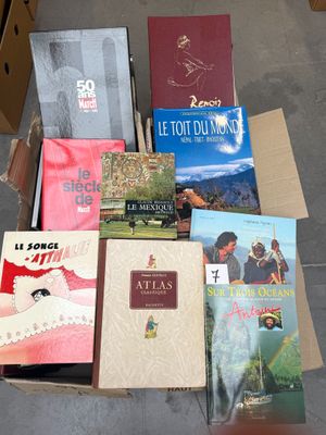 several books in a box on the floor of a room