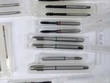 a lot of different types of sewing needles in a plastic case