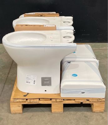 a lot of toilets sitting on a pallet in a warehouse