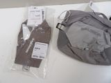 two bags of clothing on the table next to each other