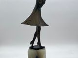 an image of a statue of a woman in a dress on a marble base
