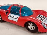 a red toy car with a sign on the side