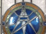 a stained glass window with a figure on it