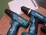two electric tools that are sitting on top of a table