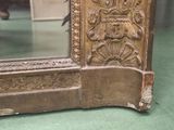 a mirror that is sitting on the floor in front of a door