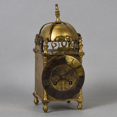 a gold clock with a dome on top of it