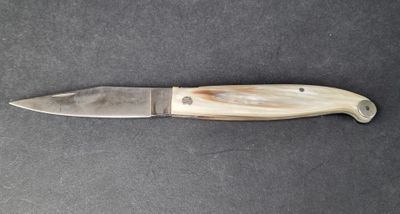 a picture of a knife that is on a table
