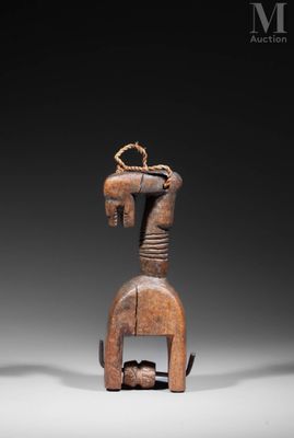 a wooden sculpture of a horse with a head on it ' s back