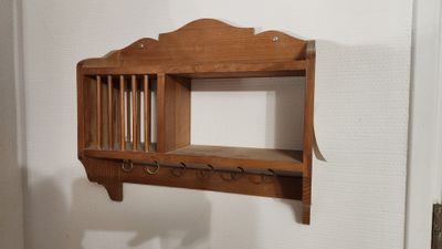 une étagère en bois avec des crochets et un porte-manteau fixé au mur