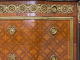 a chest of drawers that has a marble top on it