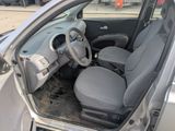 the interior of a small car with a steering wheel and seat covers