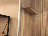 a small table and a shelf in the corner of a room