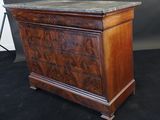 an antique chest of drawers with marble top
