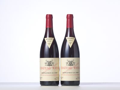 two bottles of red wine sitting next to each other on a table