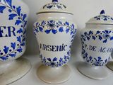 three blue and white vases are sitting on a white table