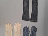 three pairs of gloves and a pair of gloves on a table