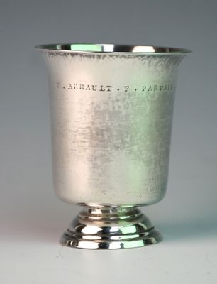 a silver cup that is sitting on a table