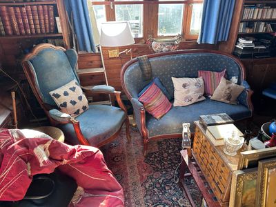 a living room with a couch, chair, and bookshelf