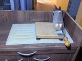a kitchen counter with a cutting board and a knife on it