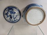 two blue and white vases on display on a glass shelf