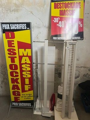 two signs that are on display in the corner of a room