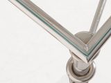 close up of a glass table with a metal frame and a glass top