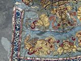 a blue and gold oriental robe on the ground