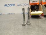 two screws that are sitting on a table