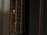 a close up of a clock on a pole near a door