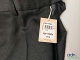 a label on the pants of a man that is wearing a tie