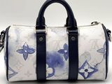 a white and blue handbag with blue flowers on it