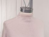 the top of a pink sweater is on a mannequin mannequin