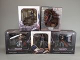 three boxes of assorted action figures sitting on top of a table