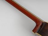 a close up of a guitar with a wooden neck and back