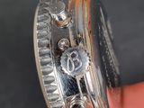 a close up of a person holding a watch in their hand