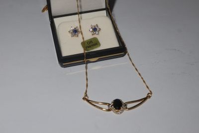 a necklace and earring set in a box on a table
