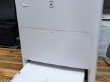 a white printer sitting on top of a wooden floor