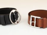two belts with buckles on each side of them on a white surface