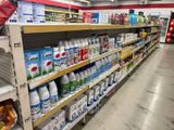 a man that is standing in a grocery store aisle